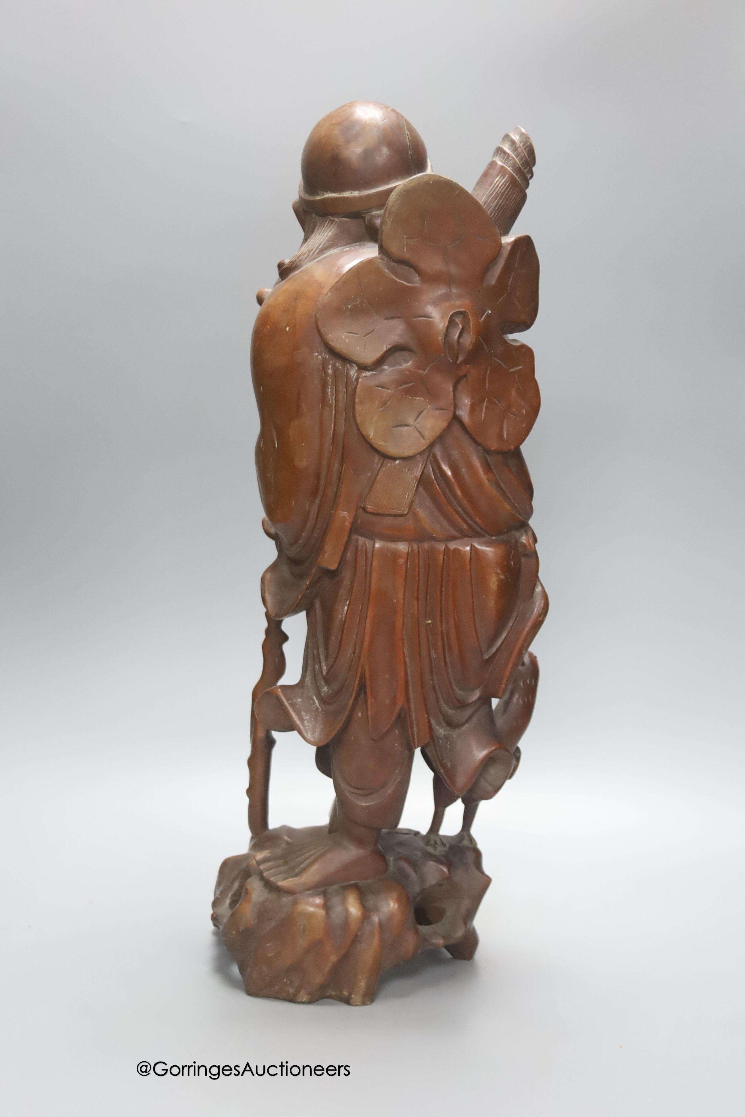 An early 20th century Chinese hardwood carving of a luohan figure, height 52cm